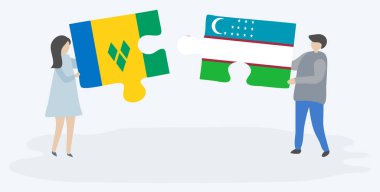 Vincentian ve Özbek bayrakları ile iki bulmaca parçaları tutan çift. Saint Vincent ve Grenadinler ve Özbekistan ulusal sembolleri birlikte.