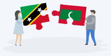 Çift Kittitian ve Maldiv bayrakları ile iki bulmaca parçaları tutan. Saint Kitts ve Nevis ve Maldivler ulusal semboller birlikte.