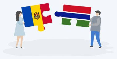 Moldova ve Gambiya bayraklarıyla iki bulmaca tutan çift. Moldova ve Gambiya ulusal sembolleri birlikte.