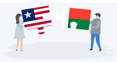 Liberya ve Malagasy bayrakları ile iki bulmaca parçaları tutan çift. Liberya ve Madagaskar ulusal sembolleri birlikte.
