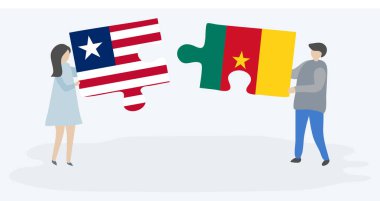 Liberya ve Kamerun bayrakları ile iki bulmaca parçaları tutan çift. Liberya ve Kamerun ulusal sembolleri birlikte.