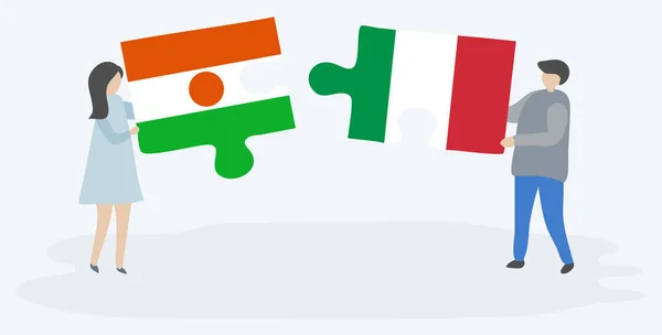 一对夫妇拿着两块拼图 上面挂着尼日尔和意大利国旗 尼日尔和意大利国家符号在一起 — 图库矢量图片