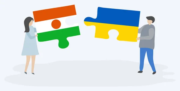 Пара Держащая Две Головоломки Нигерийскими Украинскими Флагами Нигер Национальные Символы — стоковый вектор