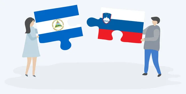 Para Trzyma Dwa Kawałki Puzzli Nikaraguan Słoweńskich Flag Nikaragua Słowenia — Wektor stockowy