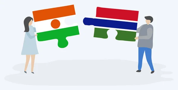 Casal Segurando Duas Peças Quebra Cabeças Com Bandeiras Nigerianas Gambianas — Vetor de Stock