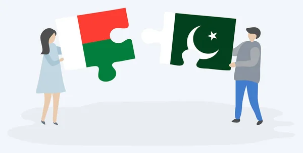 Casal Segurando Duas Peças Quebra Cabeças Com Bandeiras Malgaxes Paquistanesas — Vetor de Stock