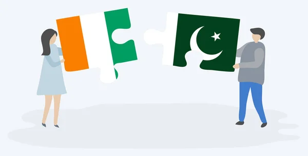 Casal Segurando Duas Peças Quebra Cabeças Com Bandeiras Marfinenses Paquistanesas — Vetor de Stock
