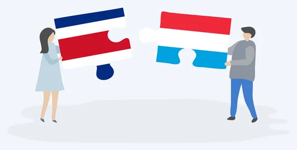 Couple Tenant Deux Pièces Puzzles Avec Des Drapeaux Costaricain Luxembourgeois — Image vectorielle