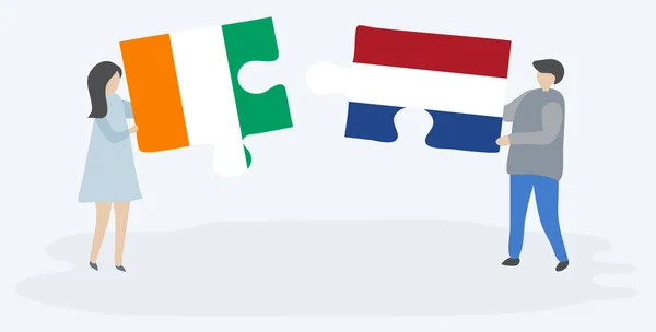Pareja Sosteniendo Dos Piezas Rompecabezas Con Banderas Marfileñas Holandesas Costa — Archivo Imágenes Vectoriales