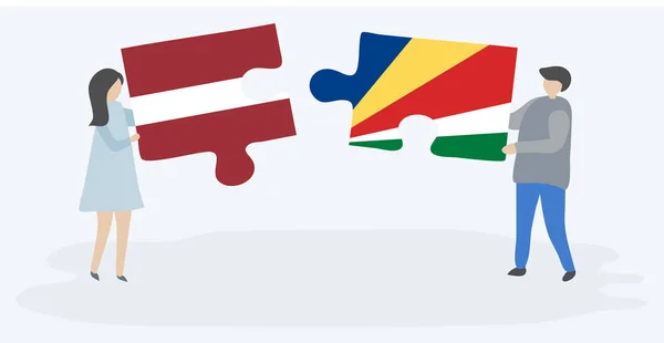 Dvojice Která Drží Dvě Skládanky Vlajkou Lotyštiny Seychellois Národní Symboly Royalty Free Stock Vektory