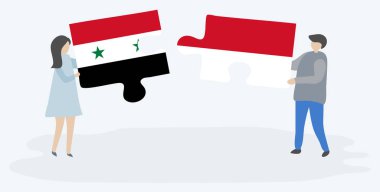 Suriye ve Monegasque bayrakları ile iki bulmaca parçaları tutan çift. Suriye ve Monako ulusal sembolleri birlikte.