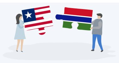 Liberya ve Gambiya bayrakları ile iki bulmaca parçaları tutan çift. Liberya ve Gambiya ulusal sembolleri birlikte.