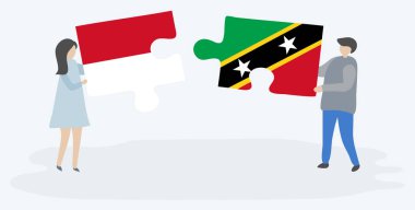 Monegasque ve Kittitian bayrakları ile iki bulmaca parçaları tutan çift. Monako ve Saint Kitts ve Nevis ulusal sembolleri birlikte.