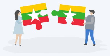 Çift Birmanya ve Birmanya bayrakları ile iki bulmaca parçaları tutan. Myanmar ve Myanmar ulusal sembolleri birlikte.