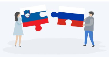 Sloven ve Rus bayrakları ile iki bulmaca parçaları tutan çift. Slovenya ve Rusya ulusal sembolleri bir arada.