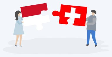 Monegasque ve İsviçre bayrakları ile iki bulmaca parçaları tutan çift. Monako ve İsviçre ulusal sembolleri birlikte.