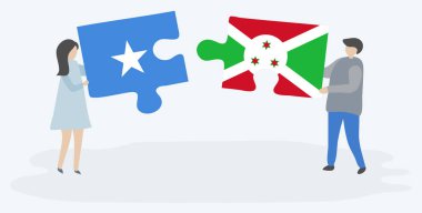 Somali ve Burundi bayraklarıyla iki bulmaca tutan çift. Somali ve Burundi ulusal sembolleri birlikte.