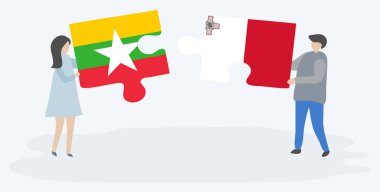 Birmanya ve Malta bayrakları yla iki bulmaca tutan çift. Myanmar ve Malta ulusal sembolleri birlikte.