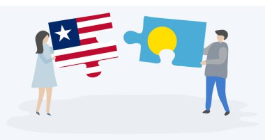 Liberya ve Palauan bayrakları ile iki bulmaca parçaları tutan çift. Liberya ve Palau ulusal sembolleri birlikte.