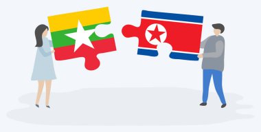 Birmanya ve Kuzey Kore bayrakları ile iki bulmaca parçaları tutan çift. Myanmar ve Kuzey Kore ulusal sembolleri birlikte.