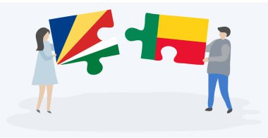 Seychellois ve Beninese bayrakları ile iki bulmaca parçaları tutan çift. Seyşeller ve Benin ulusal sembolleri birlikte.