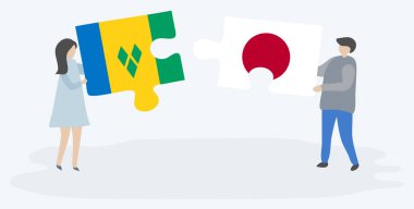 Vincentian ve Japon bayrakları ile iki bulmaca parçaları tutan çift. Saint Vincent ve Grenadinler ve Japonya ulusal sembolleri birlikte.