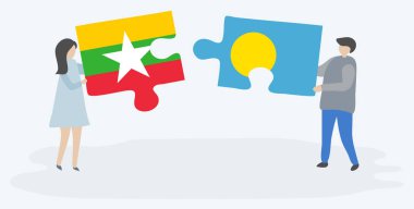 Çift Birmanya ve Palauan bayrakları ile iki bulmaca parçaları tutan. Myanmar ve Palau ulusal sembolleri birlikte.