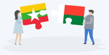 Çift Birmanya ve Malagasy bayrakları ile iki bulmaca parçaları tutan. Myanmar ve Madagaskar ulusal sembolleri birlikte.