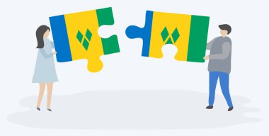 Vincentian ve Vincentian bayrakları ile iki bulmaca parçaları tutan çift. Saint Vincent ve Grenadinler ve Saint Vincent ve Grenadinler ulusal sembolleri birlikte.