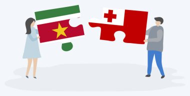 Surinam ve Tongan bayrakları ile iki bulmaca parçaları tutan çift. Surinam ve Tonga ulusal sembolleri birlikte.