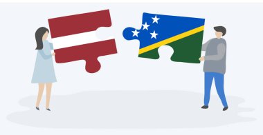 Leton ve Solomon Adası bayrakları ile iki bulmaca parçaları tutan çift. Letonya ve Solomon Adaları ulusal sembolleri birlikte.