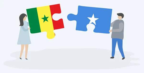 Casal Segurando Duas Peças Quebra Cabeças Com Bandeiras Senegalesas Somalis — Vetor de Stock