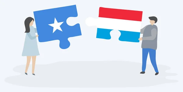 Dvojice Drží Dvě Skládanky Vlajkami Somali Luxembourgish Národní Symboly Somálska — Stockový vektor