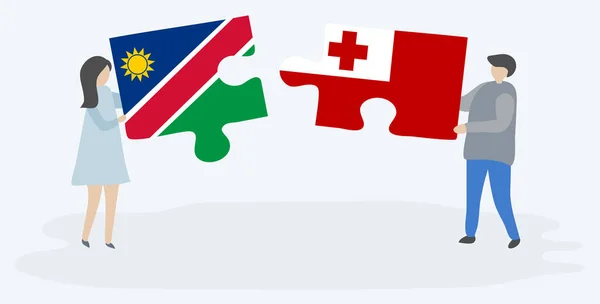 Pareja Sosteniendo Dos Piezas Rompecabezas Con Banderas Namibia Tonga Namibia — Vector de stock