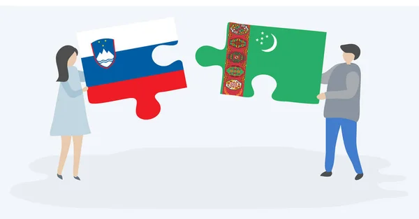 スロベニアとトルクメンの旗を持つ2つのパズルピースを保持しているカップル スロベニアとトルクメニスタンの国のシンボル — ストックベクタ