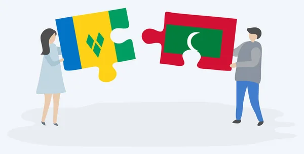 Couple Tenant Deux Pièces Puzzles Avec Des Drapeaux Vincentiens Maldiviens — Image vectorielle