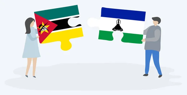 Para Trzyma Dwa Kawałki Puzzli Flagami Mozambicki Basotho Mozambik Lesotho — Wektor stockowy