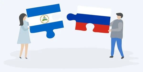 Para Trzyma Dwa Kawałki Puzzli Nikaraguan Rosyjskich Flag Nikaragua Rosja — Wektor stockowy