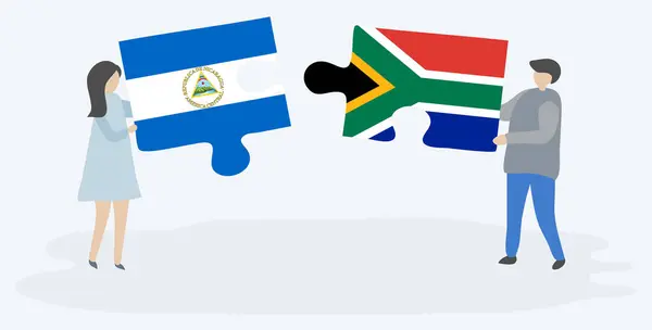 Pareja Sosteniendo Dos Piezas Rompecabezas Con Banderas Nicaragüenses Sudafricanas Nicaragua — Vector de stock