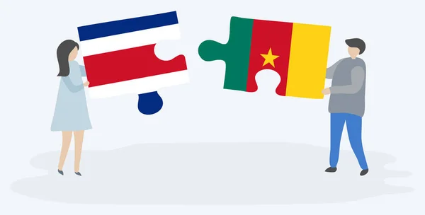 Pareja Sosteniendo Dos Piezas Rompecabezas Con Banderas Costa Rica Camerún — Vector de stock