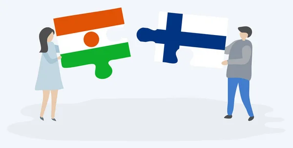 Para Trzyma Dwa Kawałki Puzzli Nigerien Fińskich Flag Symbole Narodowe — Wektor stockowy