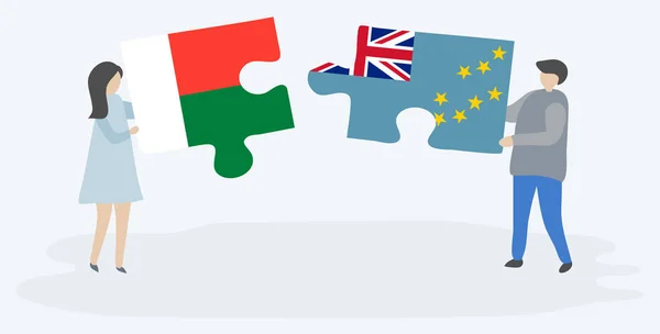 Para Trzyma Dwa Puzzle Kawałki Madagaskaru Tuvalu Flagi Madagaskar Tuvalu — Wektor stockowy