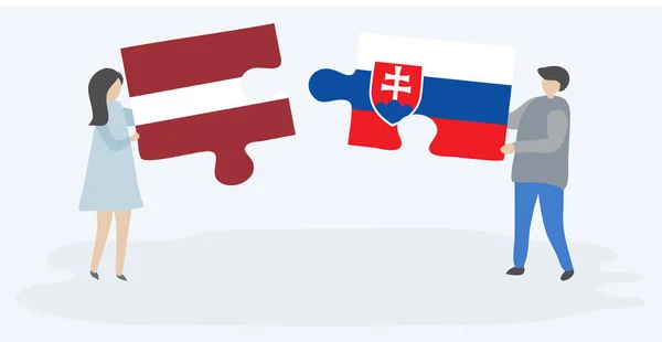 ラトビアとスロバキアの旗を持つ2つのパズルピースを保持しているカップル ラトビアとスロバキアの国のシンボル — ストックベクタ