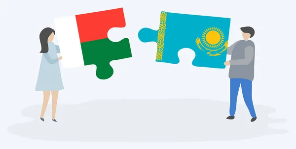 一对夫妇拿着两块拼图 上面挂着马达加斯加和哈萨克国旗 马达加斯加和哈萨克斯坦国家符号在一起 — 图库矢量图片