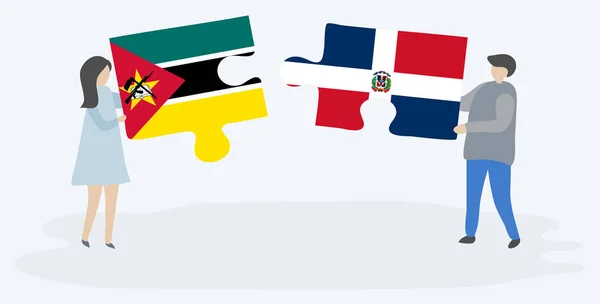 一对夫妇拿着两块拼图 上面挂着莫桑比克和多米尼加国旗 莫桑比克和多米尼加共和国国家符号在一起 — 图库矢量图片