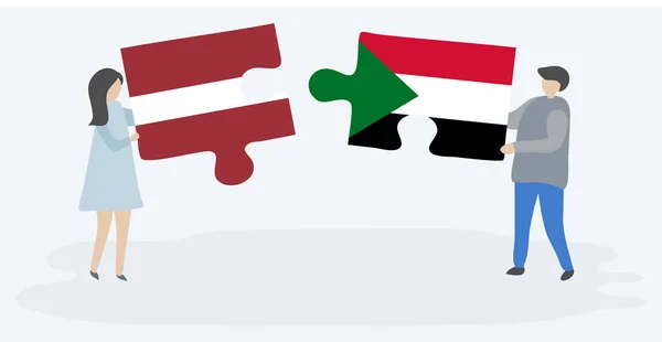 Dvojice Drží Dvě Skládanky Lotyšskými Súdánskými Vlajkami Národní Symboly Lotyšska — Stockový vektor