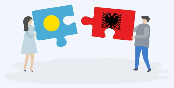 Para Trzyma Dwa Kawałki Puzzli Palauan Albańskich Flag Palau Albania — Wektor stockowy
