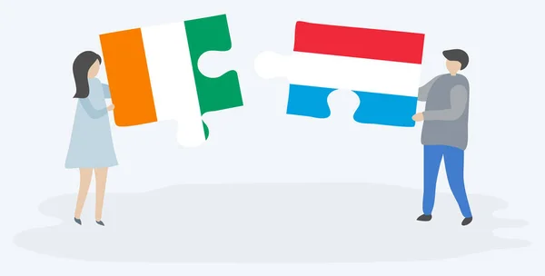 Casal Segurando Duas Peças Quebra Cabeças Com Bandeiras Marfinenses Luxemburguesas —  Vetores de Stock