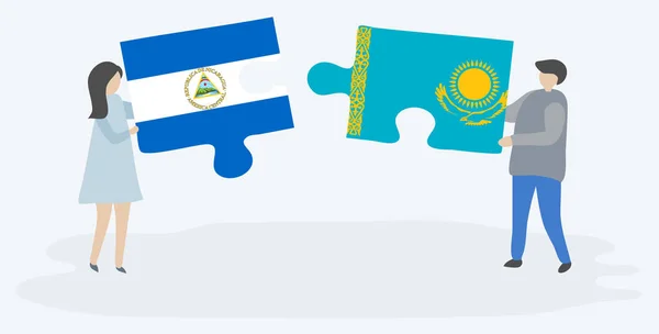 Para Trzyma Dwa Kawałki Puzzli Nikaraguan Kazachski Flagi Nikaragua Kazachstanu — Wektor stockowy