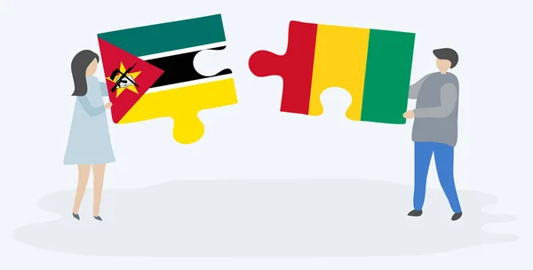 Mozambik Gine Bayrakları Ile Iki Bulmaca Parçaları Tutan Çift Mozambik — Stok Vektör